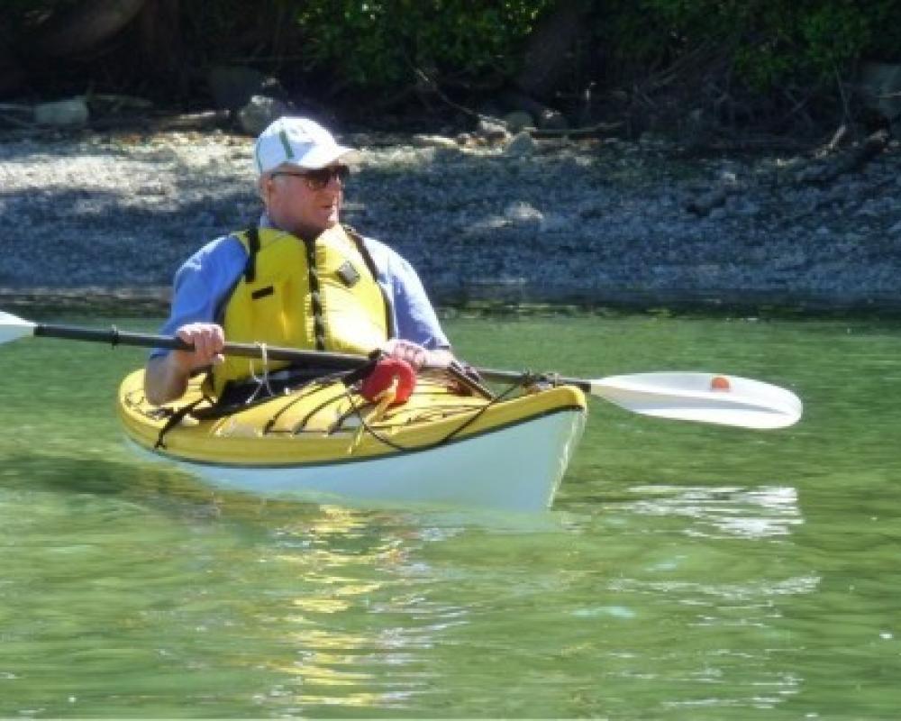 Kayaker on the beach in front of Ainslie Point cottage Pender Island